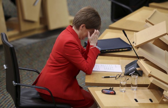 Scotland&#039;s First Minister Nicola Sturgeon reacts at the Scottish Parliament in Edinburgh, Scotland, Tuesday Dec. 22, 2020, where she gives an update on COVID-19 restrictions. Scotland has imposed ...