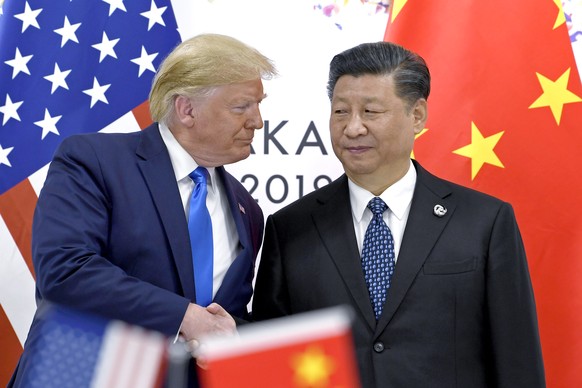 FILE - In this June 29, 2019, file photo, U.S. President Donald Trump, left, shakes hands with Chinese President Xi Jinping during a meeting on the sidelines of the G-20 summit in Osaka, western Japan ...