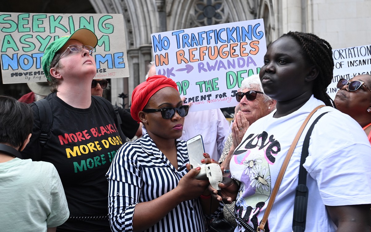 epa10011094 Human rights campaigners react after losing an appeal outside the High Court in London, Britain, 13 June 2022. An Appeal Court judge has ruled against stopping the UK Home Office from flyi ...