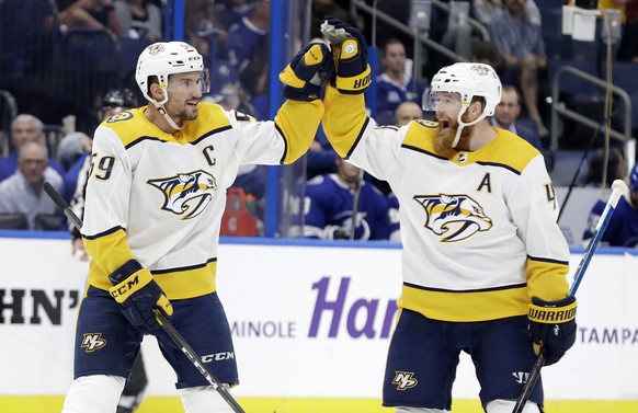 Nashville Predators defenseman Roman Josi (59) celebrates his goal against the Tampa Bay Lightning with defenseman Ryan Ellis (4) during the first period of an NHL hockey game Thursday, Nov. 1, 2018,  ...