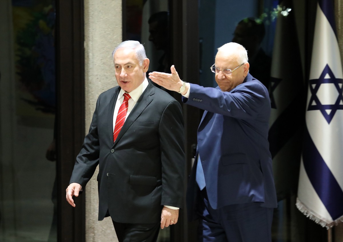 epa07869069 Israeli President Reuven Rivlin (R) welcomes Israeli Prime Minister and Chairman of the Likud Party Benjamin Netanyahu (L) before handing a letter of appointment for entrusted with forming ...