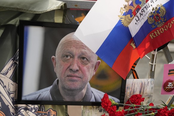 FILE - A portrait of the owner of mercenary chief Yevgeny Prigozhin decorates an informal street memorial near the Kremlin in Moscow, Russia, on Saturday, Aug. 26, 2023. Prigozhin and his top lieutena ...