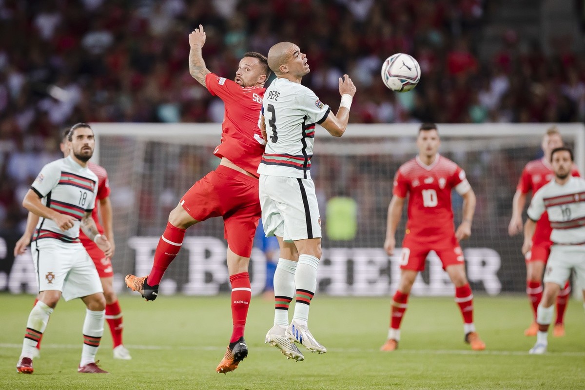 Switzerland's forward Haris Seferovic, center left, fights for the ball with Portugal's defender Pepe, right, during the UEFA Nations League group A2 soccer match between Switzerland and Por ...