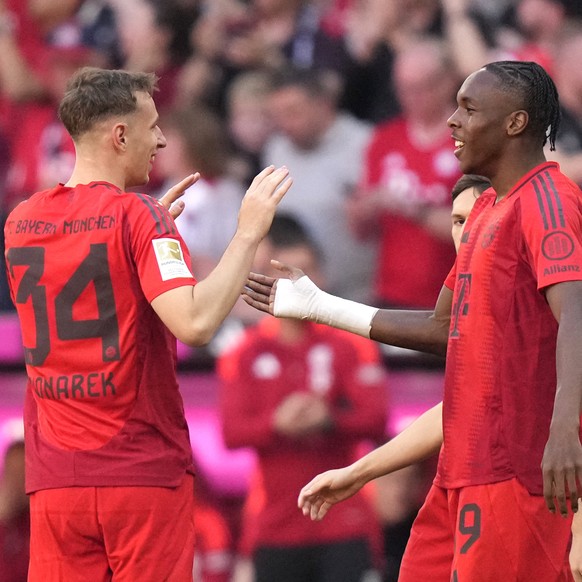 Bayern&#039;s Lovro Zvonarek, left, celebrates after scoring his side&#039;s opening goal during the German Bundesliga soccer match between Bayern Munich and VfL Wolfsburg at the Allianz Arena in Muni ...