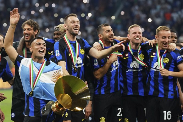 Inter Players with Lautaro Martinez, right, celebrate winning the Scudetto after the Serie A soccer match between Inter and Lazio at the San Siro Stadium, in Milan, Italy, Sunday, May 19, 2024. (Spada ...