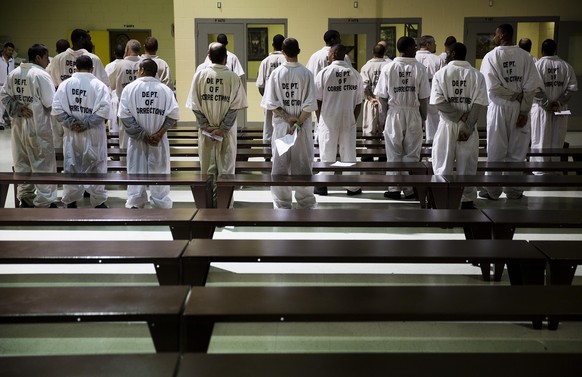 FILE - In this Dec. 1, 2015, file photo prisoners stand while being processed for intake at the Georgia Diagnostic and Classification Prison in Jackson, Ga. The U.S. Department of Justice on Tuesday,  ...