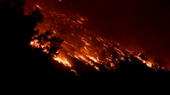 epa10765116 A wildfire burns at the Trapeza village, in Achaia Peloponnese, Greece, 23 July 2023. There is an extreme, category 5, fire risk high alert also for 24 July, for five Greek regions of Atti ...