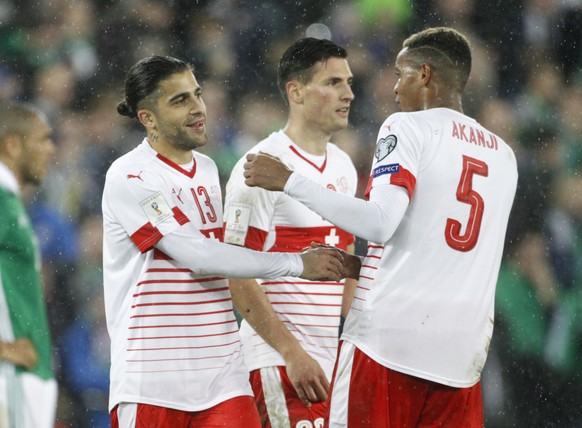 Switzerland's Ricardo Rodriguez, left, celebrates with Manuel Akanji after the World Cup qualifying play-off first leg soccer match between Northern Ireland and Switzerland at Windsor Park in Belfast, ...