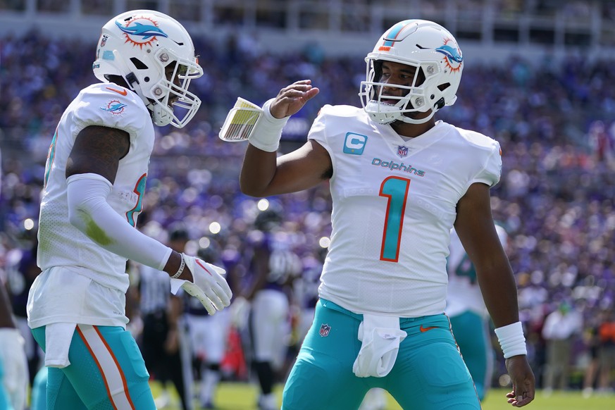 Miami Dolphins wide receiver Jaylen Waddle (17) and quarterback Tua Tagovailoa (1) celebrate a touchdown during the first half of an NFL football game against the Baltimore Ravens, Sunday, Sept. 18, 2 ...