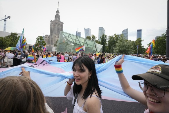 People take part in the yearly pride parade, known as the Equality Parade, in Warsaw, Poland, on Saturday, June 17, 2023. (AP Photo/Czarek Sokolowski)