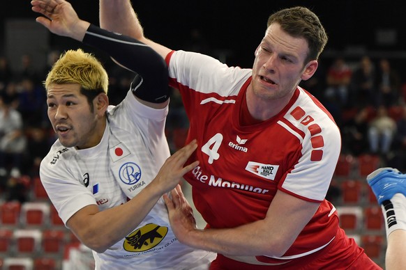 Swiss player Lenny Rubin, right, against Shinnosuke Tokuda, right, from Japan during the Yellow Cup Handball game between Switzerland and Japan in Switzerland, Winterthur, Friday, January 4, 2019. (KE ...