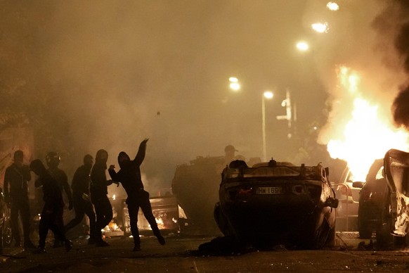 TILE - Young people clash with police forces in Nanterre, outside Paris, Thursday, June 29, 2023. After six years in power, French President Emmanuel Macron appears further weakened by days of riots over ...