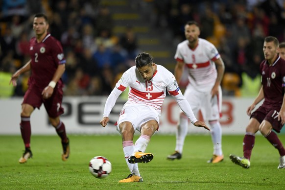 epa06181896 Swiss defender Ricardo Rodriguez scores the 3-0 lead from the penalty spot during the 2018 Fifa World Cup group B qualifying soccer match Latvia against Switzerland at Skonto Stadium, in R ...