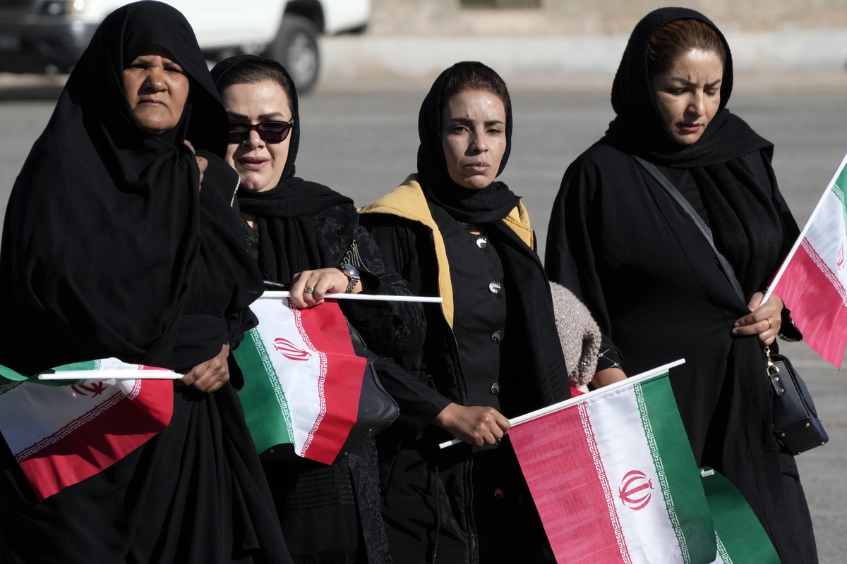 Holding Iranian flags, people attend the funeral ceremony of the victims of Wednesday's bomb explosion in the city of Kerman about 510 miles (820 kms) southeast of the capital Tehran, Iran, Frida ...