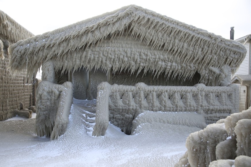 Houses along Hoover Beach is covered by ice from high winds and from the waves from Lake Erie, Saturday, Feb. 29, 2020, in Hamburg N.Y. Blowing snow has fallen around the state since Thursday, though  ...
