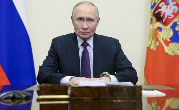 Russian President Vladimir Putin delivers a video address to congratulate employees and veterans of the Russian Prosecutor&#039;s Office on their professional holiday at the Novo-Ogaryovo state reside ...