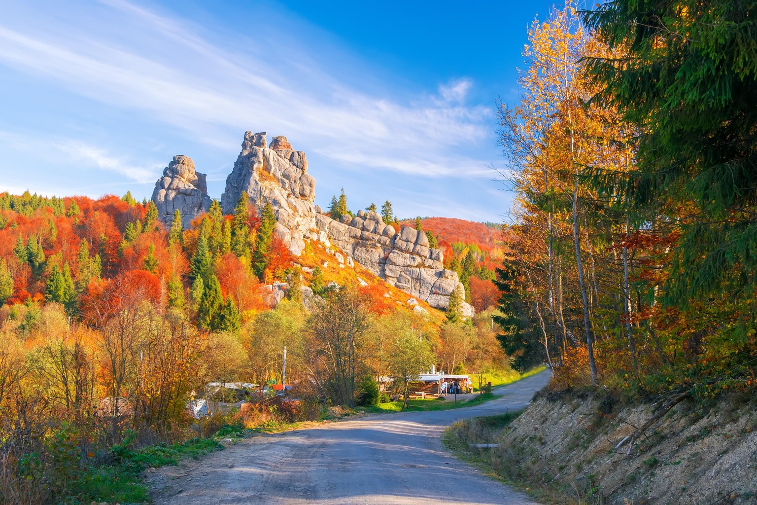 Amazing view of Tustan fortress - archaeological and natural monument of national significance, popular tourist landmark - at sunny autumn day. Location place: Urych, Carpathian Mountains, Ukraine