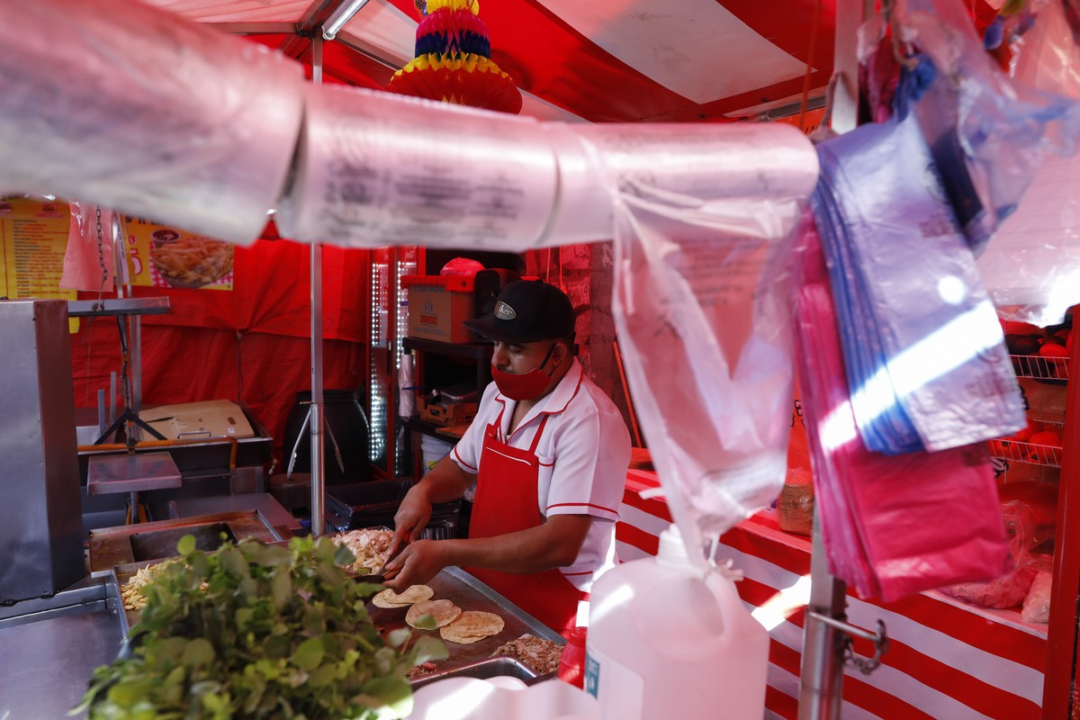 Biodegradable plastic bags, in compliance with a 2020 plastic bag ban, hang at a taco stand in central Mexico City, Friday, Jan. 1, 2021. The few street food vendors out working on New Year's Day ...
