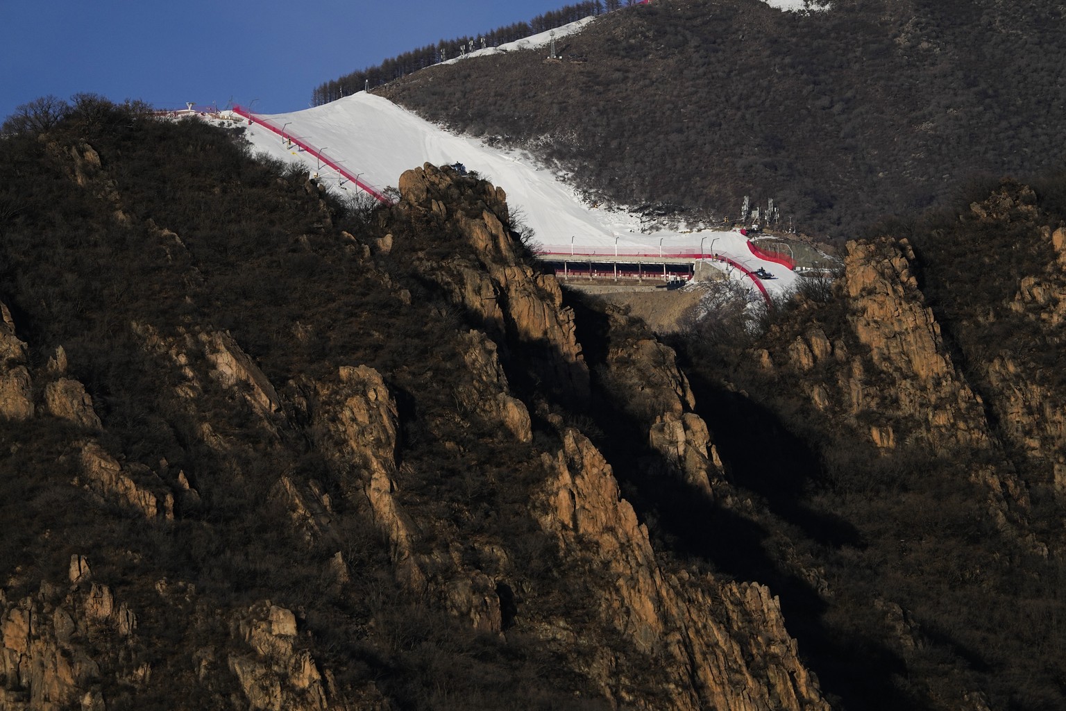 FILE - A ski slope at the National Alpine Ski Center, a venue for alpine skiing at the 2022 Winter Olympics, is pictured from the Yanqing National Sliding Center on Jan. 28, 2022, in the Yanqing distr ...