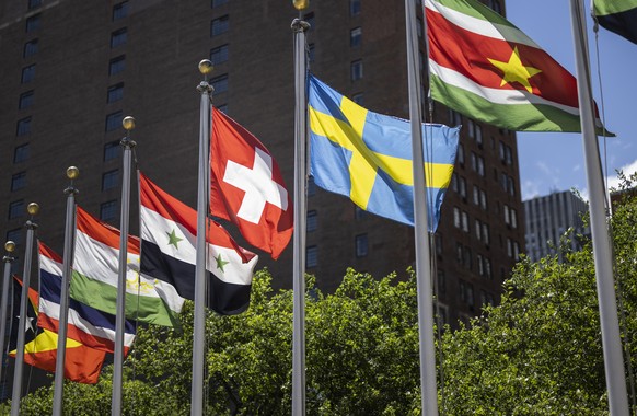 The Swiss flag, center, flies with the flags of the other member states after Switzerland&#039;s election with four other countries as non permanent members to the Security Council for the period 2023 ...