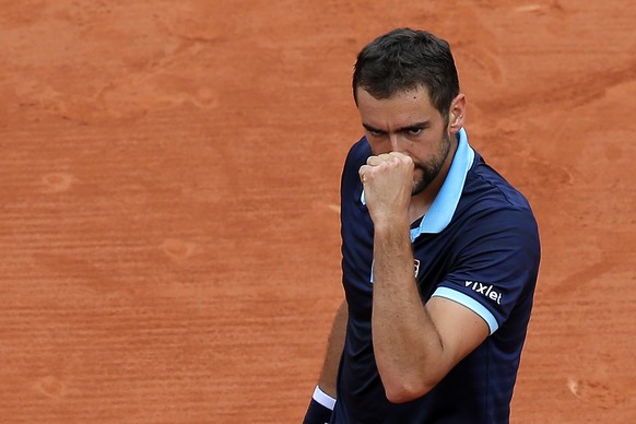 Croatia&#039;s Marin Cilic clenches his fist as he plays Spain&#039;s Feliciano Lopez during their third round match of the French Open tennis tournament at the Roland Garros stadium, Saturday, June 3 ...