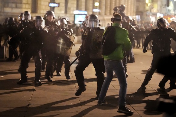 Police officers scuffle with protesters at Republique square in Paris, Tuesday, March 21, 2023. French garbage collectors, refinery workers and others are striking again.They are angry about President ...