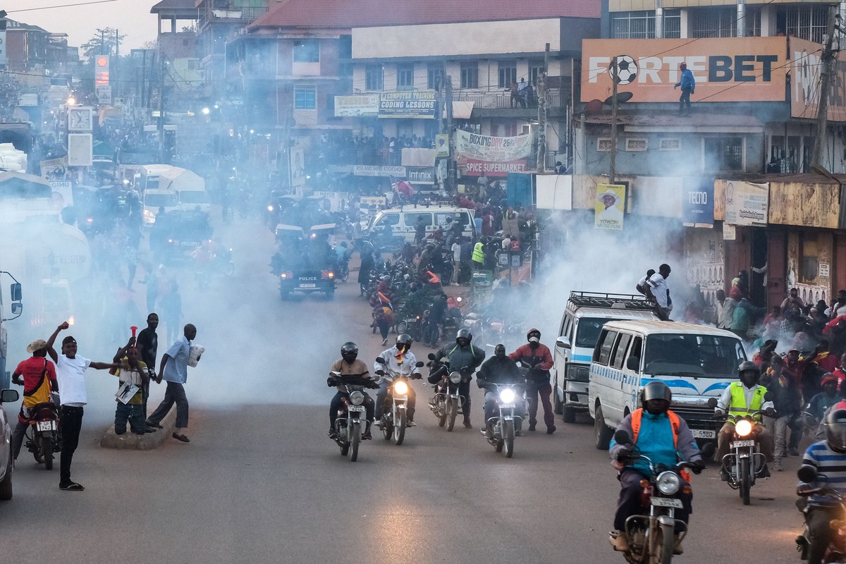 Supporters of Ugandan opposition presidential candidate Robert Kyagulanyi Ssentamu, who is known as Bobi Wine are tear-gassed by police during a campaign rally ahead of elections, in Mukono, Uganda, F ...
