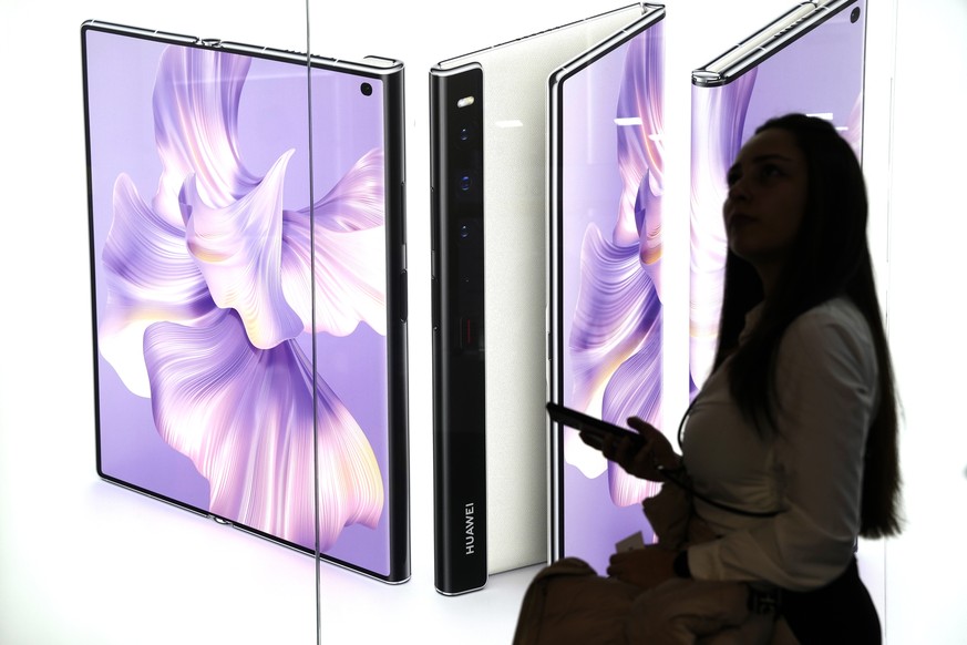 epa10495033 A visitor walks by Huawei stand at the Mobile World Congress (MWC) held at Fira Barcelona in Barcelona, Spain, 28 February 2023. MWC Barcelona, the largest and most influential event for t ...