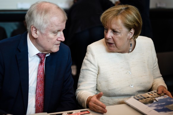 epa06802520 German Interior Minister Horst Seehofer (L) and German Chancellor Angela Merkel sit next to each other during the beginning of CDU/CSU parliamentary group meeting in Berlin, Germany, 12 Ju ...