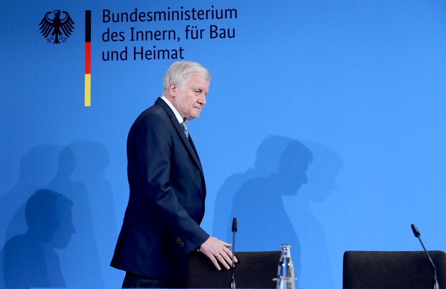 epa07748572 Minister of Interior, Construction and Homeland Horst Seehofer during a press conference reporting on the incident at the Frankfurt main station, in Berlin, Germany, 30 July 2019. An eight ...