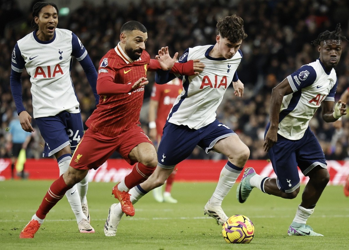 epa11790203 Tottenham Hotspurs' Archie Gray (R) and Liverpool's Mohamed Salah in action during the English Premier League soccer match beween Tottenham Hotspur and Liverpool FC, in London, B ...