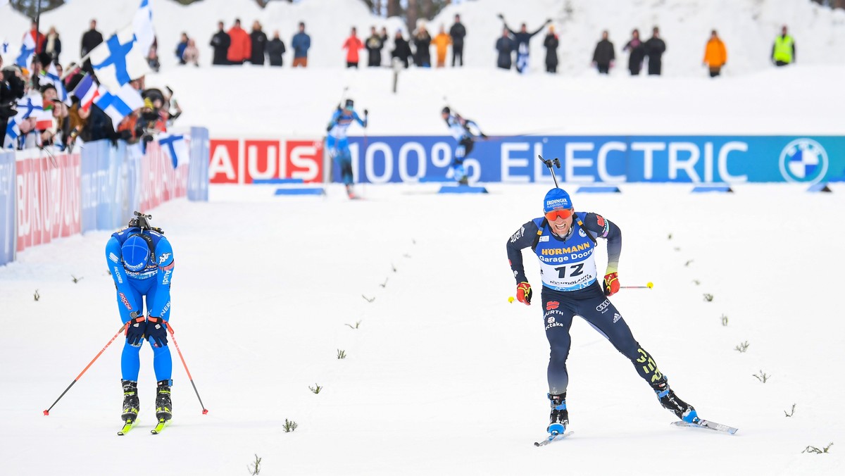 epa09805576 Erik Lesser (R) of Germany crosses the finish line to take the second place in the men's 12.5km Pursuit race of the IBU Biathlon World Cup in Kontiolahti, Finland, 06 March 2022. At l ...