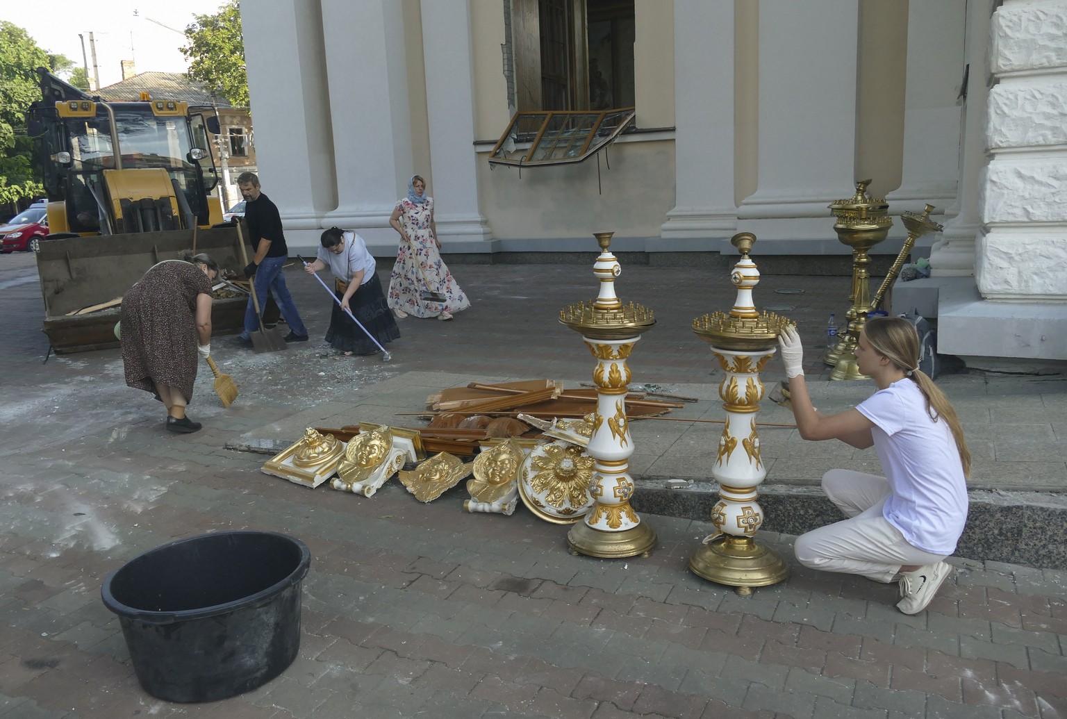 epa10763457 People collect debris of the church internal decor near the Transfiguration Cathedral, damaged by a missile attack in the Odesa region, southern Ukraine, 23 July 2023. Odesa was attacked b ...