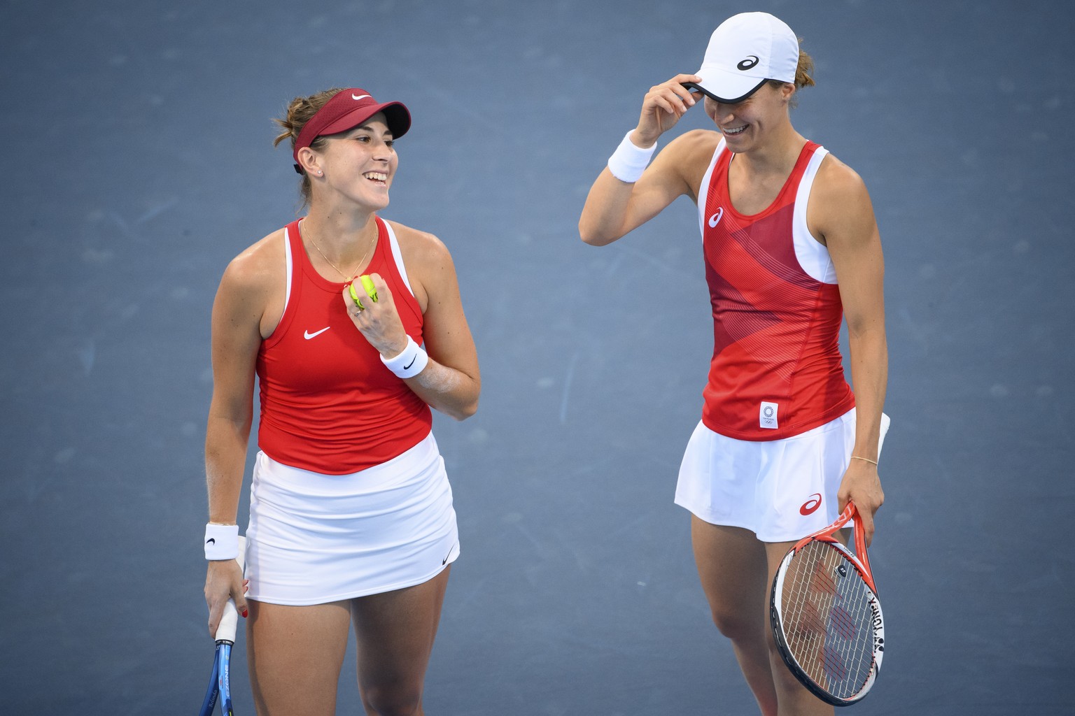 Belinda Bencic, left, and Viktorija Golubic, right, of Switzerland smile together during the game against Carla Suarez Navarro and Garbine Muguruza of Spain during the women&#039;s doubles tennis seco ...