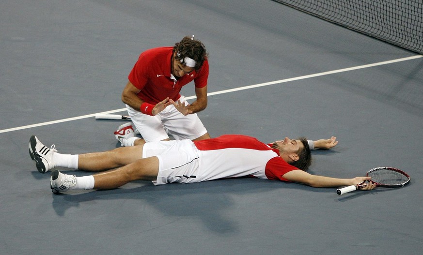 Roger Federer, left, and Stanislas Wawrinka of Switzerland react after winning their match against Bob Bryan and Mike Bryan during the semi final of the men&#039;s double tennis at the Beijing 2008 Ol ...