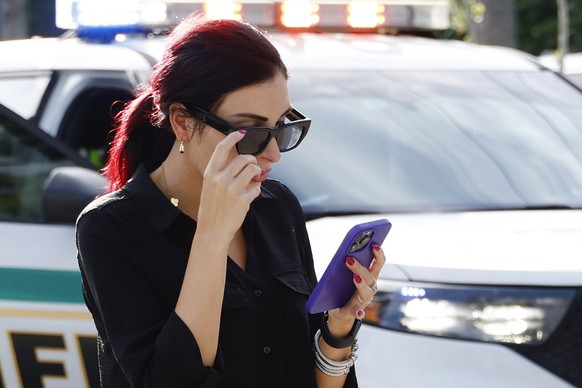 Laura Loomer uses her cell phone near Trump International Golf Club after police closed off the area following the apparent assassination attempt of Republican presidential nominee former President Do ...
