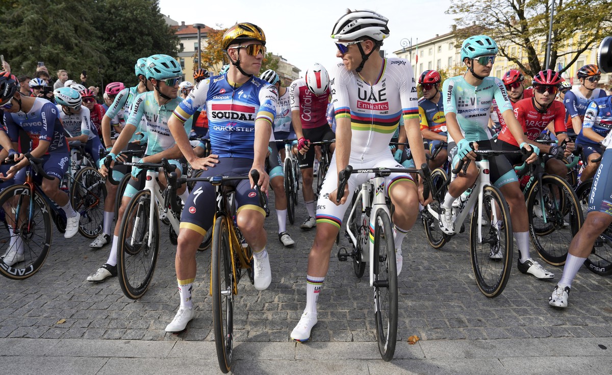 Belgium's Remco Evenepoel, left, and Slovenia's Tadej Pogacar prepare to start the Il Lombardia cycling race in Como, Italy, Saturday, Oct. 12, 2024. (Gian Mattia D'Alberto/LaPresse via ...