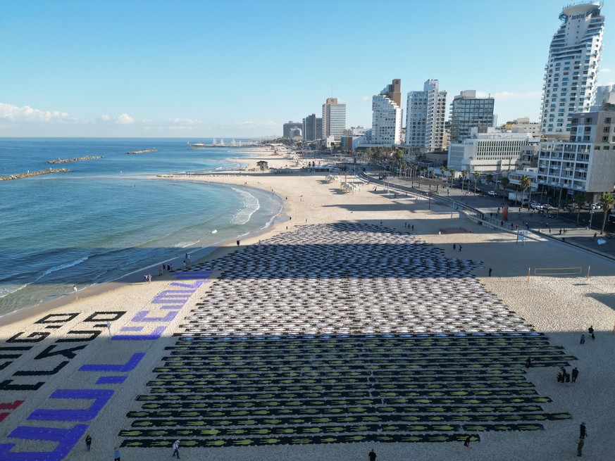 epa13286444 One thousand, two hundred humans figures, referring to the 1,200 victims killed in the Hamas-led 07 October 2023 attacks, are placed by anti-government protesters near large Hebrew letters ...