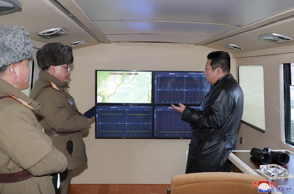 This photo provided by the North Korean government shows North Korean leader Kim Jong Un, right, looks at the monitors as a test launch of a missile on Jan. 11, 2022 in North Korea. Independent journa ...