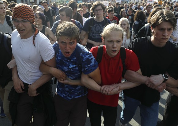 Protesters march during an unsanctioned rally in the center of Moscow, Russia, Saturday, July 27, 2019. Russian police are clashed with demonstrators and have arrested some hundreds in central Moscow  ...