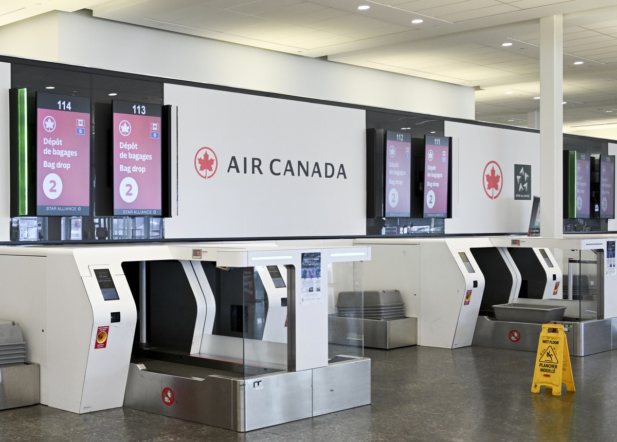 An empty Air Canada bag drop area is shown as Air Canada flight attendants strike at Montreal?Trudeau International Airport in Montreal, Saturday, Aug. 16, 2025. (Graham Hughes/The Canadian Press via  ...