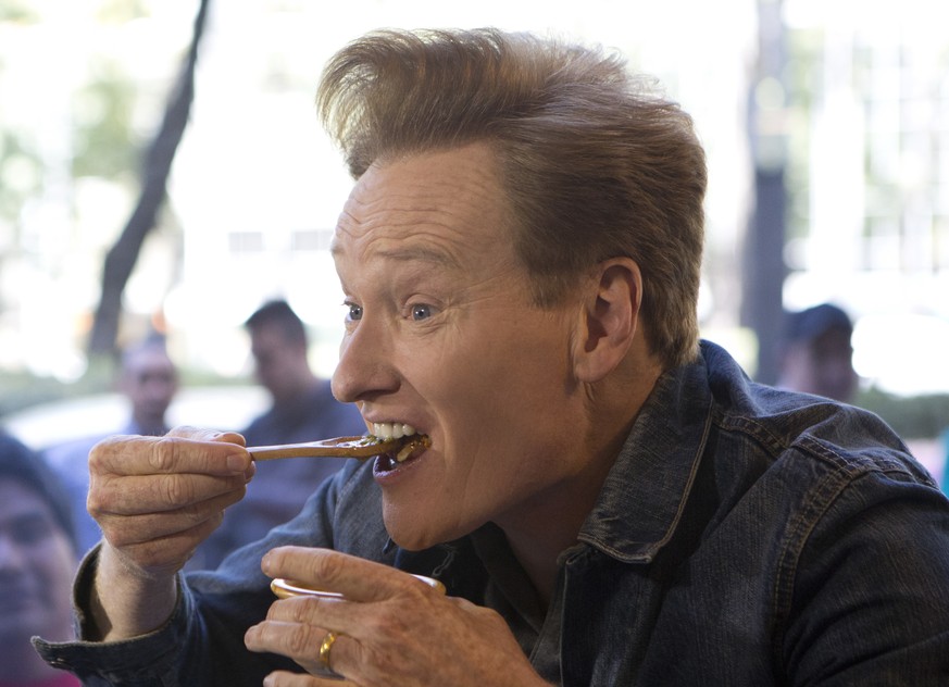 Television host Conan O&#039;Brien eats hot sauce straight out of a bowl as he tapes a segment at an upscale taco restaurant in Paseo de la Reforma boulevard in Mexico City, Monday, Feb. 20, 2017. O&# ...