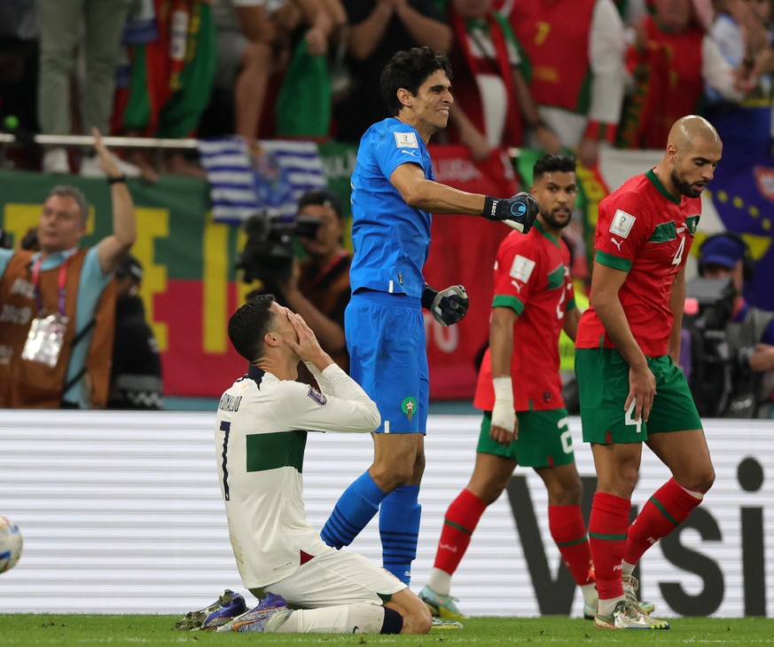 epa10359610 Cristiano Ronaldo (L) of Portugal reacts after missing a chance to score during the FIFA World Cup 2022 quarter final soccer match between Morocco and Portugal at Al Thumama Stadium in Doh ...