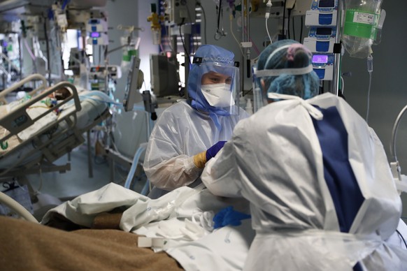 Nurses tend to a patient in a COVID-19 Intensive Care Unit at the Curry Cabral hospital in Lisbon, Thursday, Feb. 11, 2021. After Portugal figured for about two weeks last month as the worldÄôs worst ...