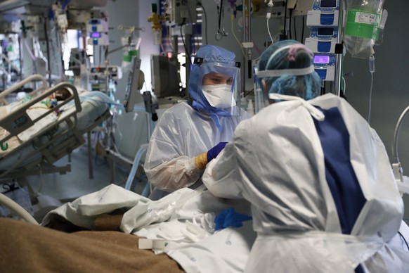 Nurses tend to a patient in a COVID-19 Intensive Care Unit at the Curry Cabral hospital in Lisbon, Thursday, Feb. 11, 2021. After Portugal figured for about two weeks last month as the worldて worst-h ...