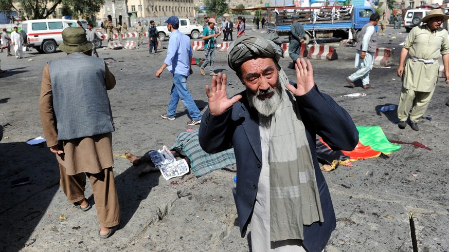epa05437824 A man from Hazara minority reacts after a suicide bomb attack that targeted a demonstration of Hazara minority in Kabul, Afghanistan, 23 July 2016. According to reports at least 20 people  ...
