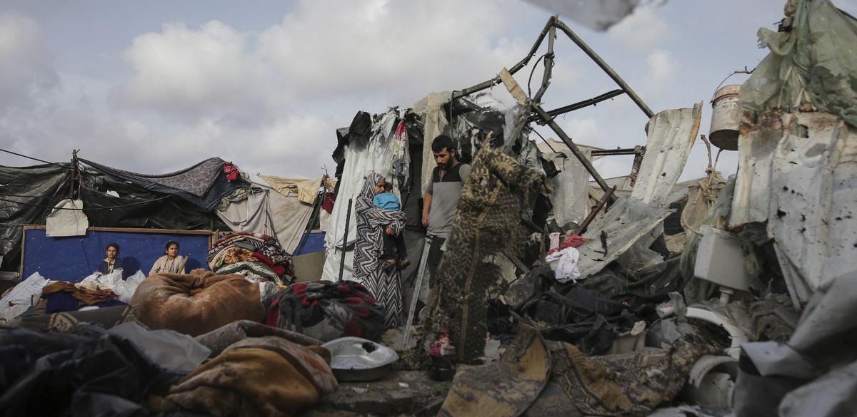 Displaced Palestinians inspect their tents destroyed by Israel's bombardment, adjunct to an UNRWA facility west of Rafah city, Gaza Strip, Tuesday, May 28, 2024. (AP Photo/Jehad Alshrafi)