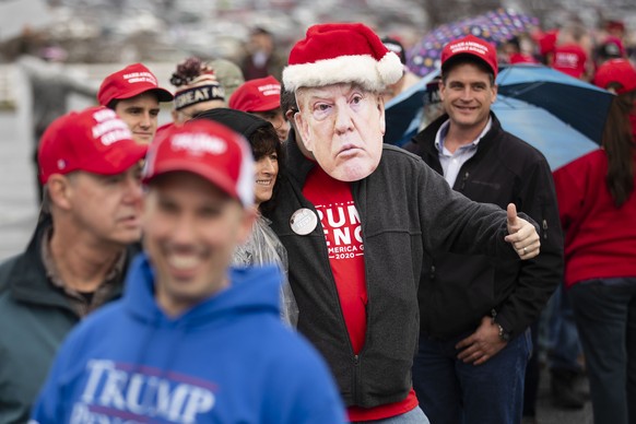 People wait in line to attend a campaign rally with President Donald Trump in Hershey, Pa., Tuesday, Dec. 10, 2019. (AP Photo/Matt Rourke)
Donald Trump