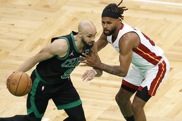 epa11313607 Boston Celtics guard Derrick White (L) gets around Miami Heat guard Patty Mills (R) during the second half of the Eastern Conference first round game five between the Boston Celtics and th ...