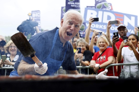 FILE - In this Sept. 21, 2019, file photo when former Vice President Joe Biden was running for president, Biden works the grill during the Polk County Democrats Steak Fry in Des Moines, Iowa. Presiden ...